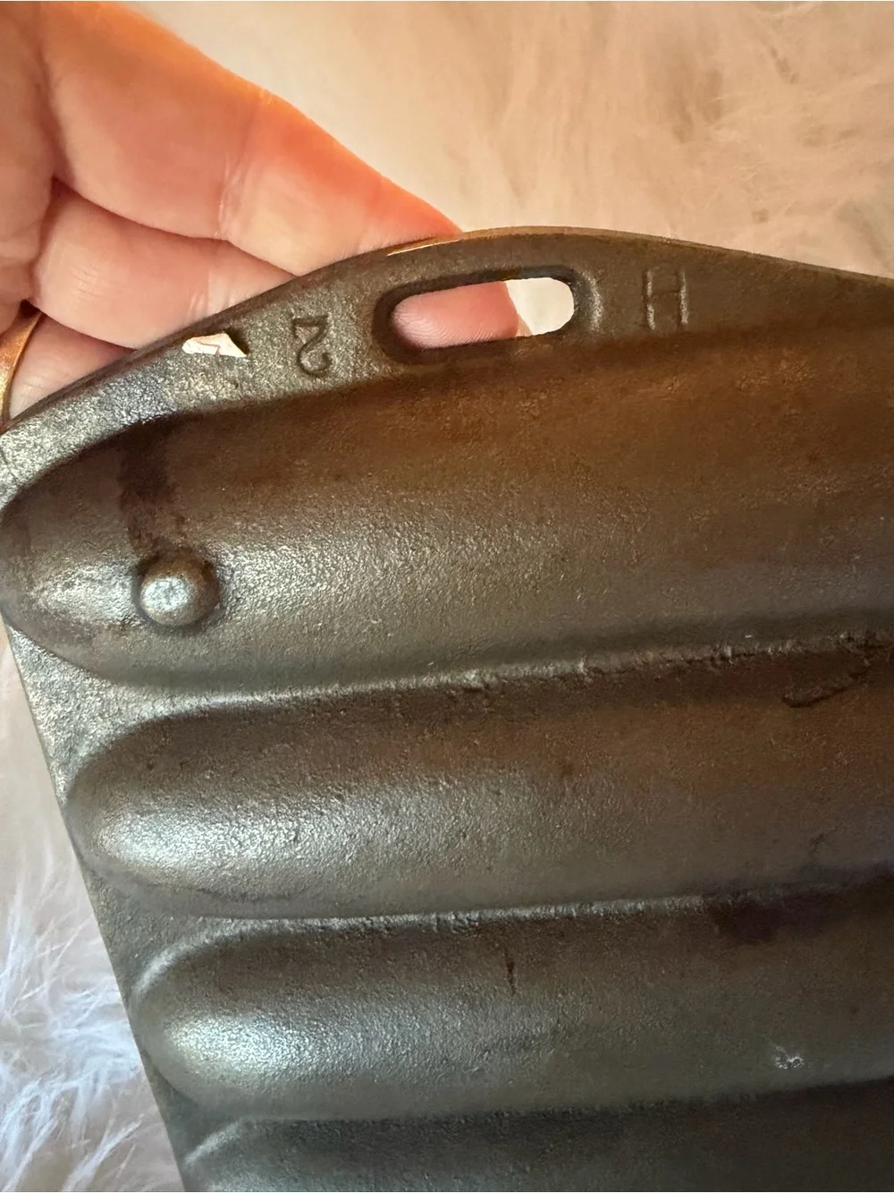 Vintage Lodge cast iron corn stick pan with seven corn cob impressions.